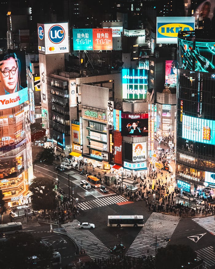Explore the bustling Shibuya Crossing in Tokyo, Japan, illuminated by vibrant city lights at night.