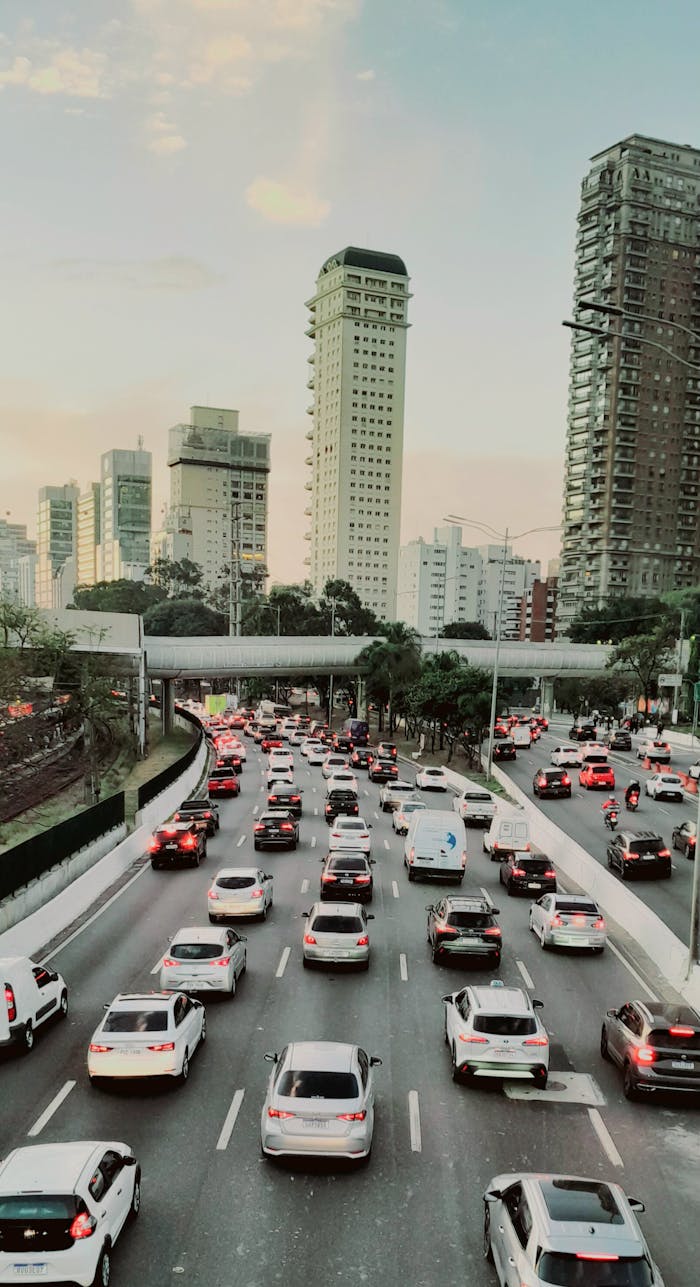 Heavy traffic crosses an expressway amidst modern skyscrapers in São Paulo, Brazil.